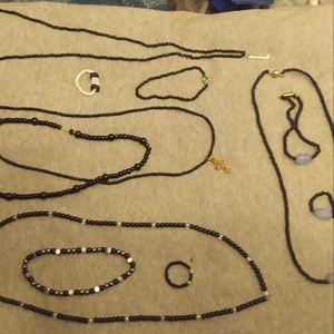 Black beads with cross charm, imagine charm, and blue